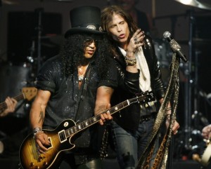 Rock guitarist Slash performs with Steven Tyler of Aerosmith at the MusiCares MAP Fund benefit concert in Hollywood
